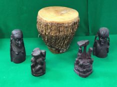 An African hide covered tribal drum, a Makonde style carved wooden family group,