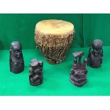 An African hide covered tribal drum, a Makonde style carved wooden family group,