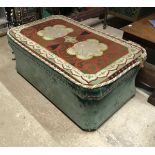 A 19th Century waisted ottoman with green velvet upholstery and needlework decorated top raised on