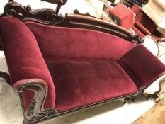 A Victorian carved mahogany framed scroll arm sofa on octagonal faceted baluster supports to