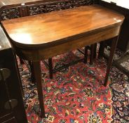 An early 19th Century mahogany fold over card table on square rosewood strung supports