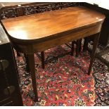 An early 19th Century mahogany fold over card table on square rosewood strung supports