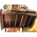 A modern mahogany open bookcase with adjustable shelving and two drawers