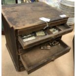 A 19th Century nine drawer dentist cabinet with various false teeth,