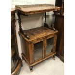 A Victorian walnut music cabinet with galleried shelf over a recess and two glazed cupboard doors