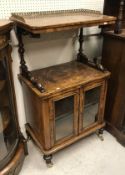 A Victorian walnut music cabinet with galleried shelf over a recess and two glazed cupboard doors