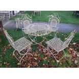 A modern (probably French) painted wrought iron circular garden table and four folding chairs with