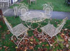 A modern (probably French) painted wrought iron circular garden table and four folding chairs with