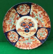 A 19th Century Japanese Imari charger decorated with panels of flowers, within a lobed rim,