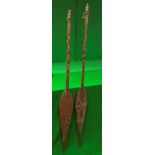 A pair of carved South Sea ceremonial paddles with carved decoration,