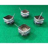 A set of four Chinese silver or white metal and blue enamel decorated salts of square form embossed