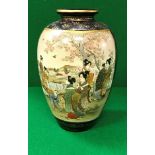 An early 20th Century Japanese Satsuma ware vase decorated with panels of figures in a garden