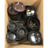 A collection of early 20th Century Japanese black lacquered lidded bowls with chysanthemum