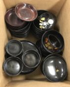 A collection of early 20th Century Japanese black lacquered lidded bowls with chysanthemum