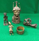 A collection of West African metal ware items to include a Benin style bust of a woman's head and