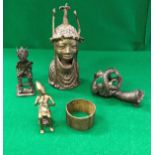 A collection of West African metal ware items to include a Benin style bust of a woman's head and