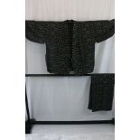 A circa 1950 cotton Sakumui (gardening) kimono with Kasuri (Japanese check) decoration on a black