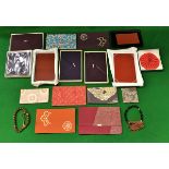 A collection of Japanese silk fukusa and small cases, some with wooden trays,