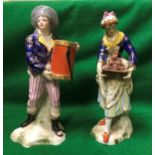 A pair of Derby figures of a cake lady and man with a hat box both bearing oxide red marks to base