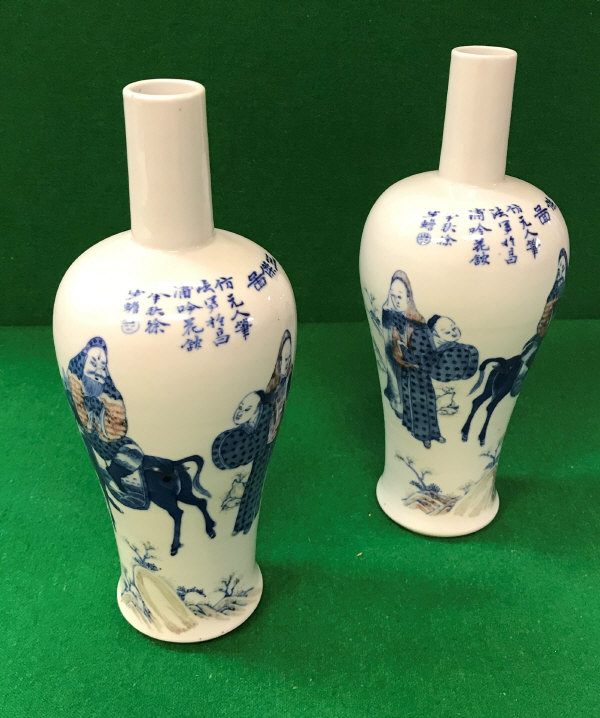 A pair of Chinese blue and white baluster shaped vases with narrow necks,