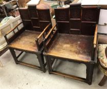 A pair of 19th Century Chinese lacquered elm throne or marriage chairs with carved medallion