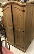 A pair of modern pine wardrobes, a pair of matching pine three drawer bedside chests,