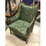 A pair of 19th Century French carved gilt wood and gesso framed wingback armchairs in the Louis