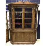 A circa 1850 bow ended walnut display cabinet in the French taste with blind doors to base and