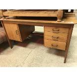 A modern teak double pedestal desk (provenance: owned and used by Philip Mackie,