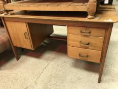 A modern teak double pedestal desk (provenance: owned and used by Philip Mackie,