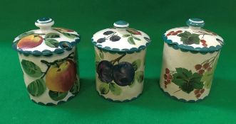 Three Wemyss preserve pots with lids, one depicting red currants,