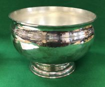 A 20th Century silver punch bowl of circular form, raised on a circular foot (by D & J Wellby,