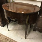 An early 19th Century French mahogany and brass inlaid oval writing table,
