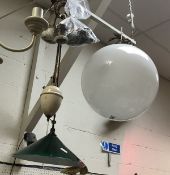 A vintage rise and fall lamp with green glass shade,
