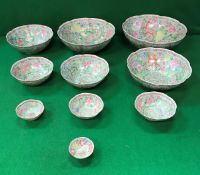 A graduated set of ten late 20th Century Chinese Gingdezhen polychrome decorated bowls bearing faux