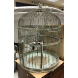 A large painted metal parrot cage