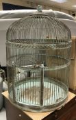 A large painted metal parrot cage