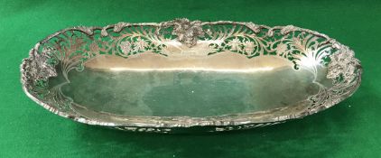 A modern silver fruit basket of elongated oval form with pierced grape and vine decoration (by F