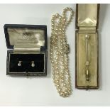 A graduated pearl single strand necklace with Art Deco style diamond encrusted clasp,