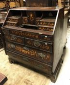A 19th Dutch mahogany and marquetry inlaid bureau of typical form