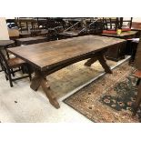 A Provincial oak plank top table on X frame base and central stretcher