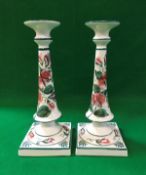 A pair of Wemyss candlesticks with Sweet Pea decoration, the bases stamped "Wemyss ware R.