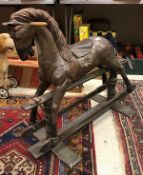 A modern painted wooden rocking horse in the 19th Century style