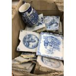 A box containing assorted blue and white Delft ware and other tiles set with various topographical