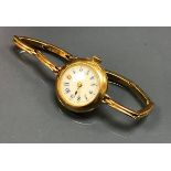 A circa 1900 ladies 18 carat gold cased wristwatch with 15 carat gold expanding bracelet