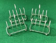 A set of four silver four section toast racks of small proportions,