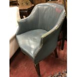 A circa 1900 blue leather upholstered and studded tub chair with square tapering front legs to