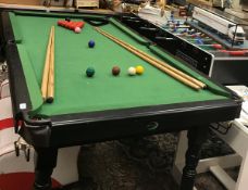 An Ambassador snooker/billiard table with cues and balls