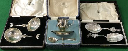A silver egg cup and spoon, pair of exotic fish decorated handled spoons,