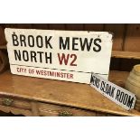 A vintage enamel road sign inscribed "Brooke Mews North W2 City of Westminster"